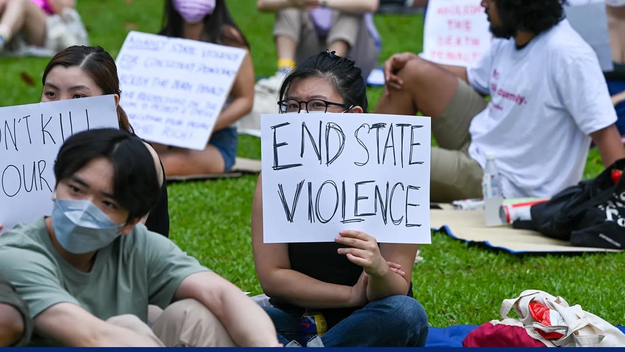 Protesters hold sign reading End State Violence
