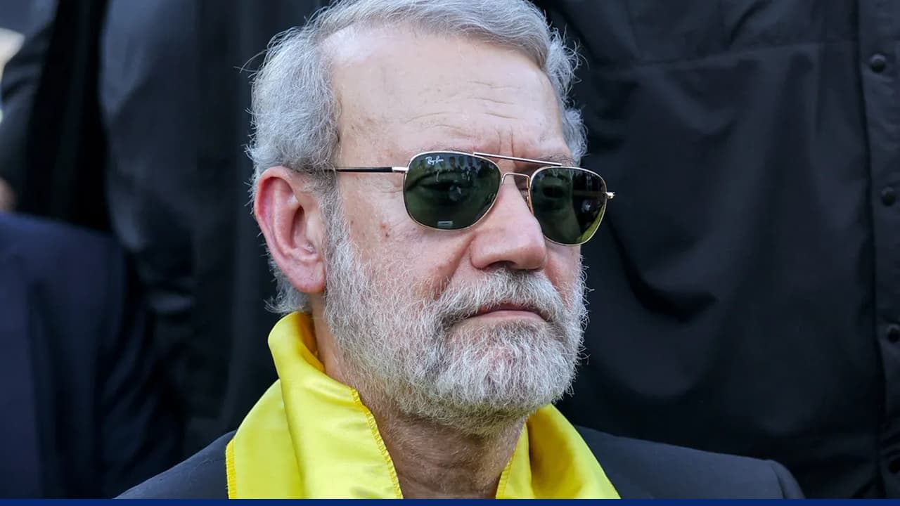 Senior Iranian official wearing sunglasses during tense public appearance