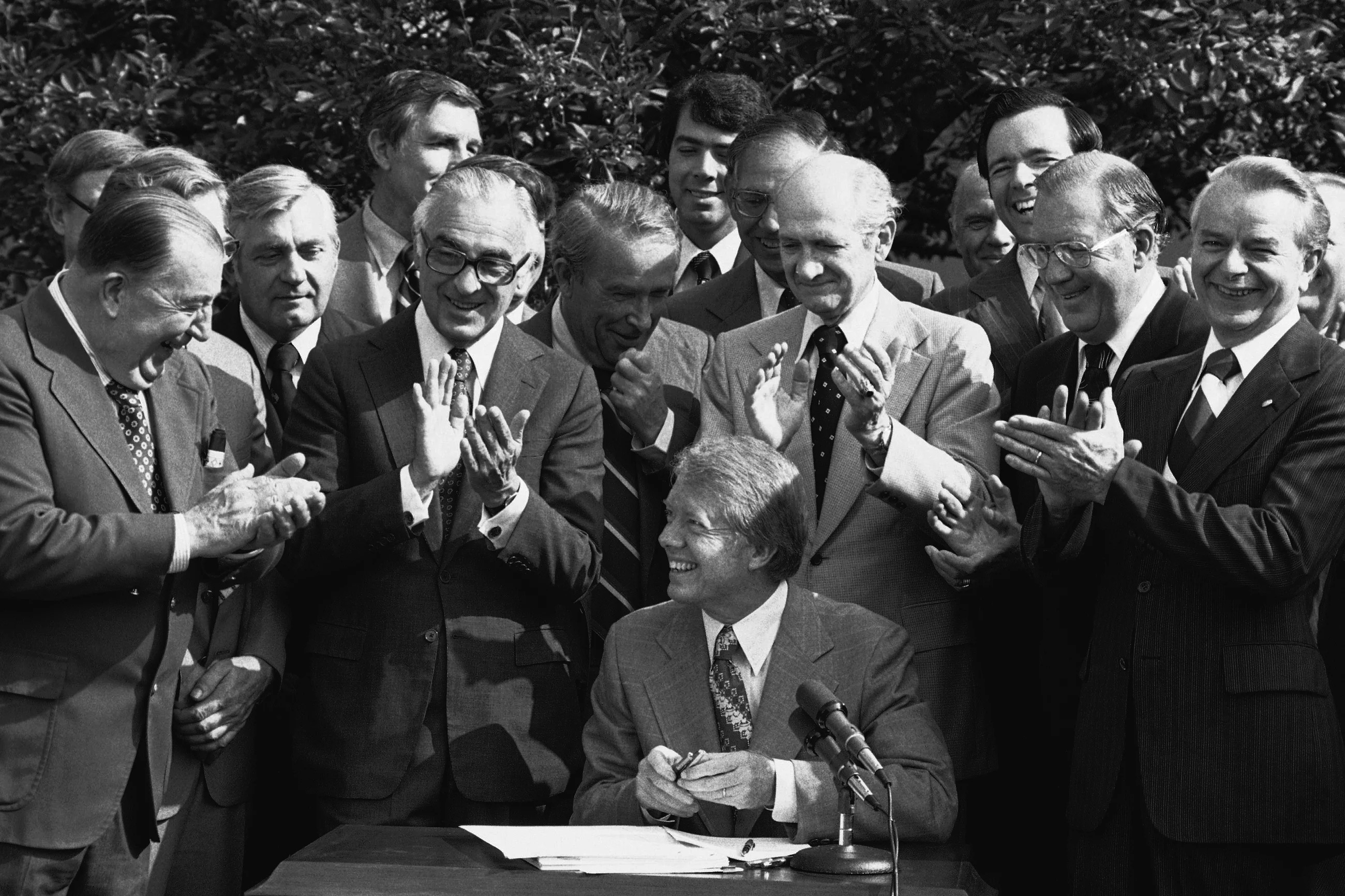 President Jimmy Carter smiles as he receives applause from members of Congress after signing a bill to create the Department of Energy during a Rose Garden ceremony at the White House in Washington, D.C., on August 4, 1977.